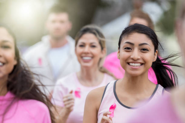 istock Young woman enjoys running in race for cure 1058047654