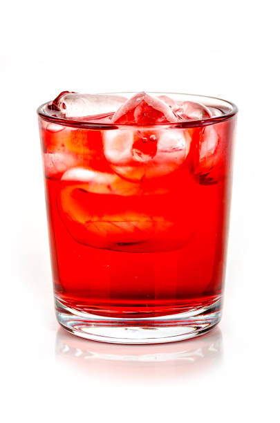 istock red drink with ice cubes on white background, isolated 1058047662