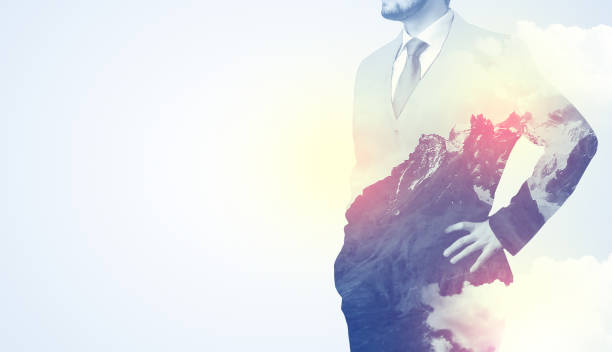 istock Businessman standing with mountain graphic 1058048354