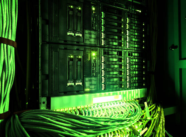 istock Close up of green network internet cables, patch cords connected to black switch router in Data center, server room. 1058048468