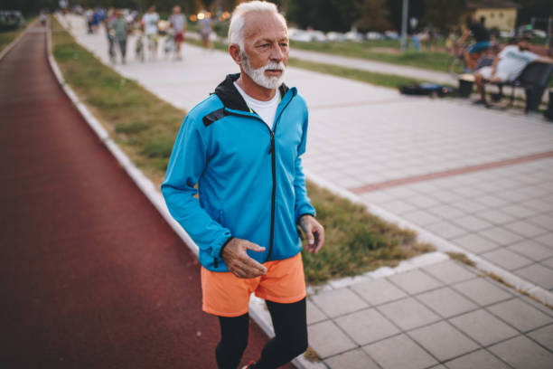 istock Bearded senior man jogging on a running track 1058049656