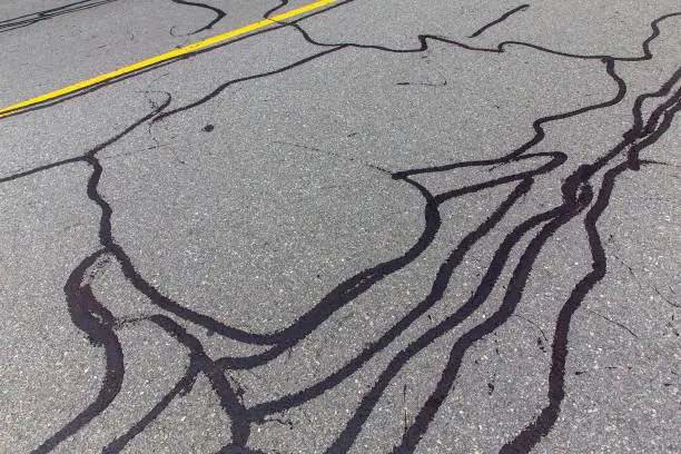 Photo of asphalt road with filled cracks