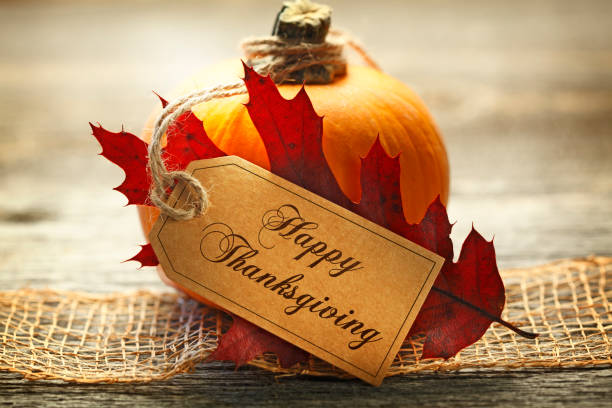 istock Happy Thanksgiving Tag Rests Against An Autumn Leaf And A Small Pumpkin 1058049976