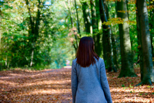 istock a woman takes a walk in the forest 1058054726
