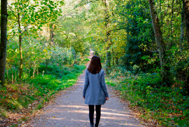 istock a woman takes a walk in the forest 1058055514
