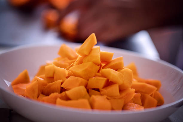 Home cooking, Indian cuisine. Pumpkin curry making. Chopped pumpkins, close-up