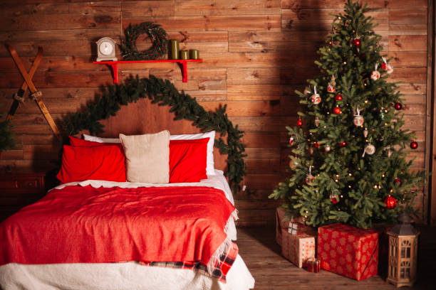 istock New year bedroom interior. Christmas tree, presents and other cozy decorations 1058056988
