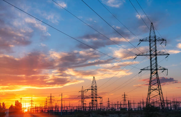 istock high-voltage lines against the background of electrical distribution stations at sunrise. 1058060676