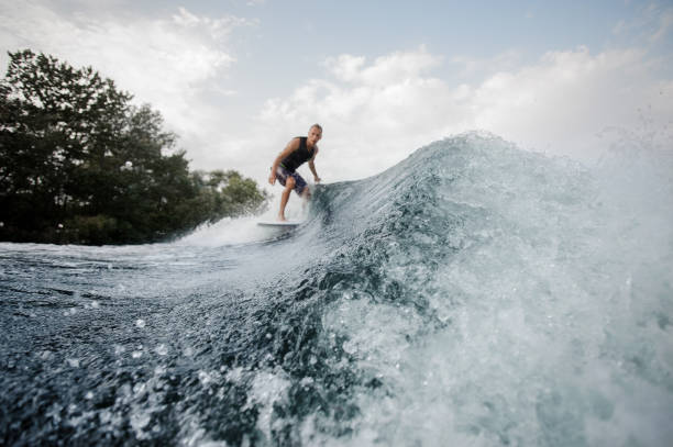istock Wakesurfer on the background and blue splashing water on foreground 1058061752