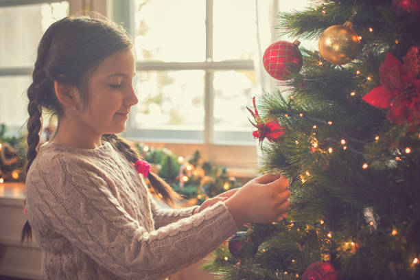 istock Girl decorating the Christmas tree 1058064032