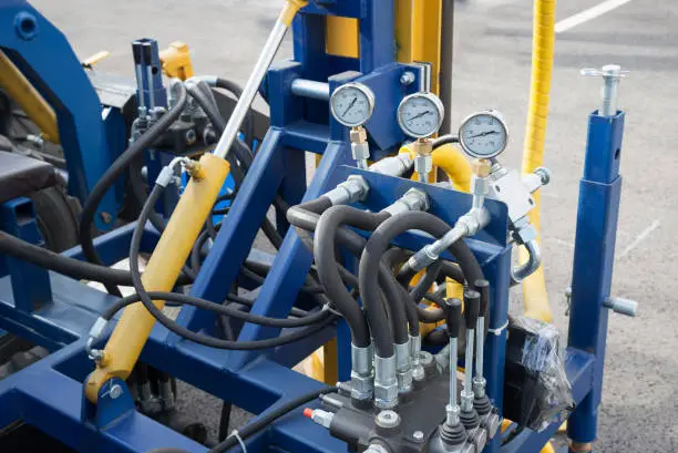 Photo of Hydraulic tubes fittings and  on control panel of lifting mechanism