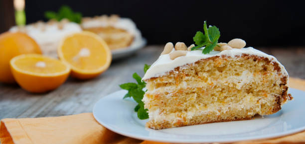 istock Orange and carrotn cake, wooden background. Rustic style. Banner. 1058067348