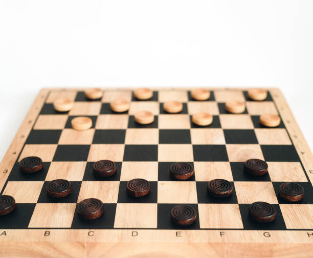 istock wooden checkerboard with checkers spaced isolated on white 1058069716