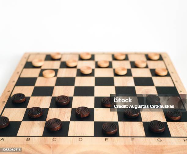 Wooden Checkerboard With Checkers Spaced Isolated On White Stock Photo - Download Image Now