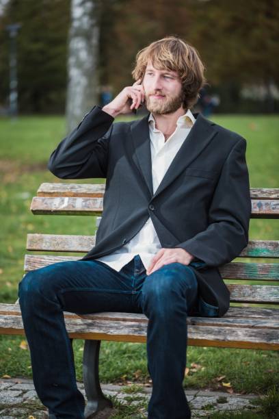 istock Business man is using a mobile phone at the park 1058073168