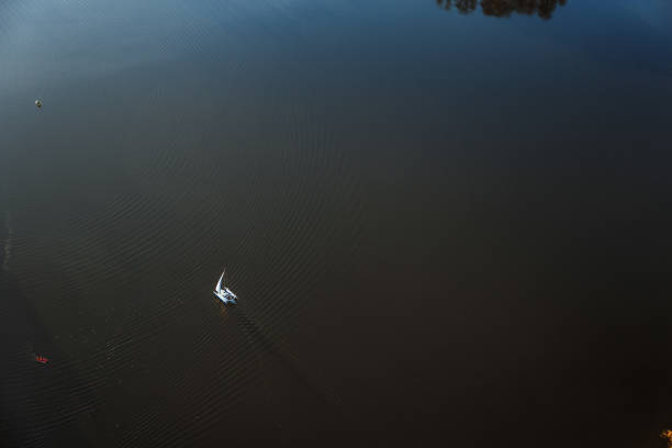 istock Countryside lake with yacht from above 1058075140