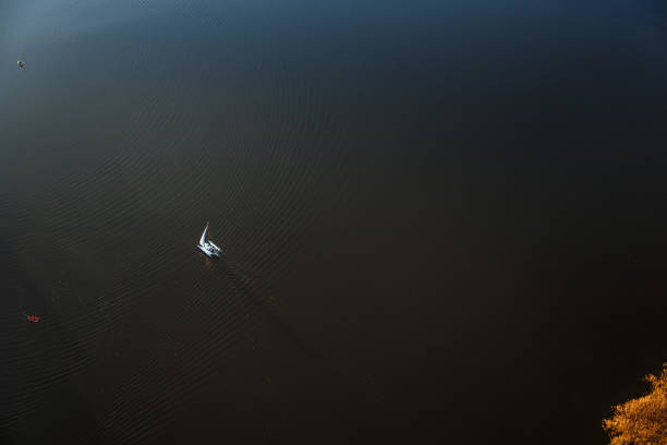 istock Countryside lake with yacht from above 1058075262