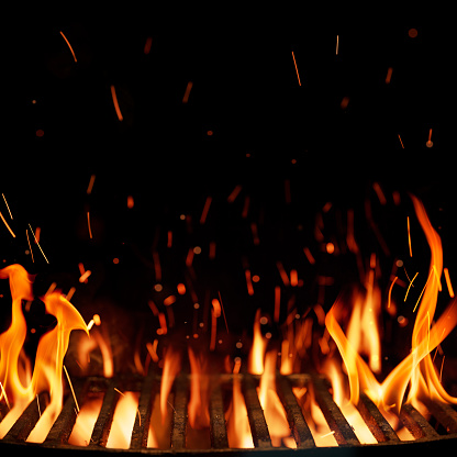 Empty grill grid with fire isolated on black background with copy space