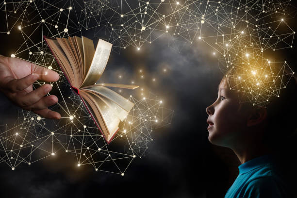 An opened book is mooving from an adult's hand towards a child.