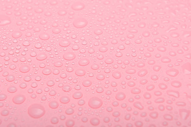 istock Water drops on a pink background. Close up 1058085210