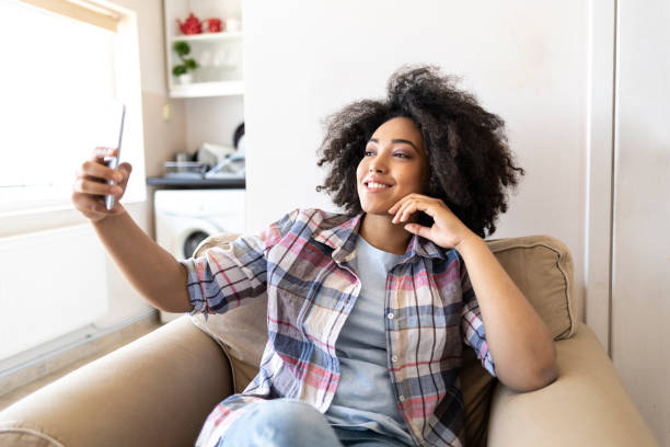 istock Woman taking selfie at home 1058091746