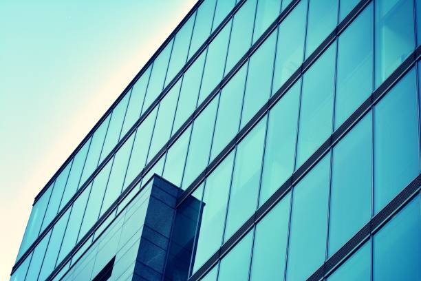 istock Modern office building on a clear sky background. Retro stylized colorful tonal filter effect 1058099476