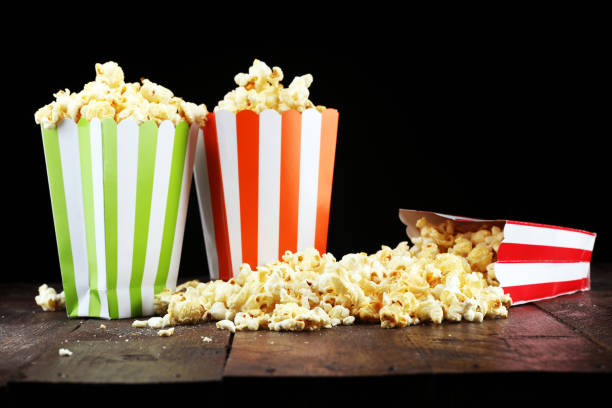 istock Cinema concept with popcorn in green white bag. 1058100830