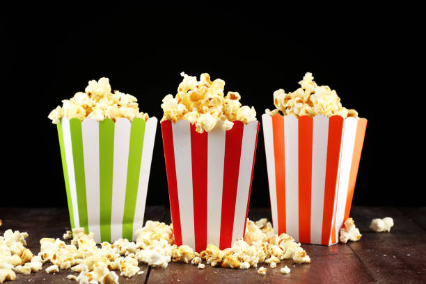 istock Cinema concept with popcorn in green white bag. 1058102088