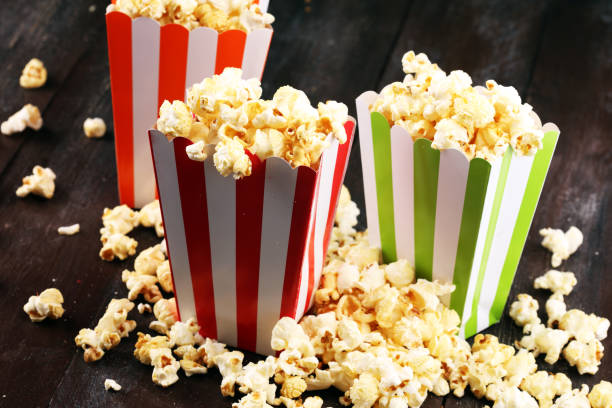 istock Cinema concept with popcorn in green white bag. 1058102226