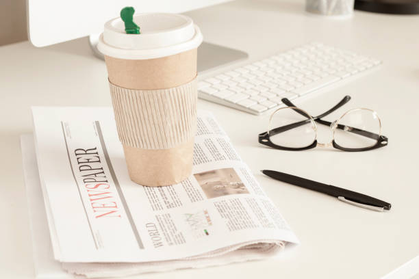 istock newspaper and coffee over office desk 1058102560