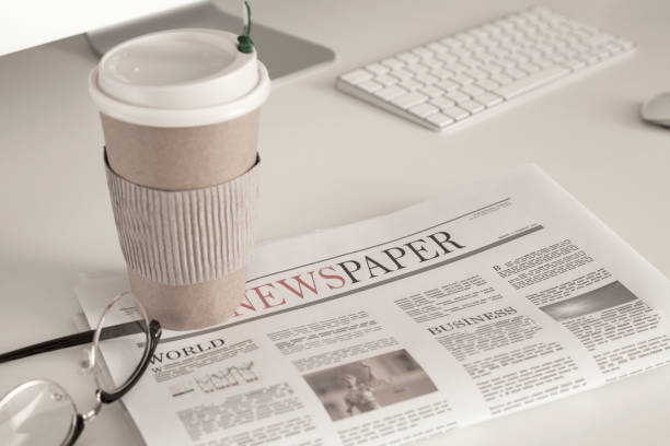 istock newspaper and coffee over office desk 1058102714