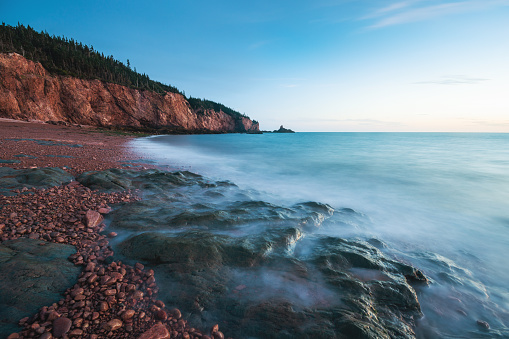 A long exposure of the eroded cliffs and rocky beach at low tide near Cape Chignecto, Nova Scotia.