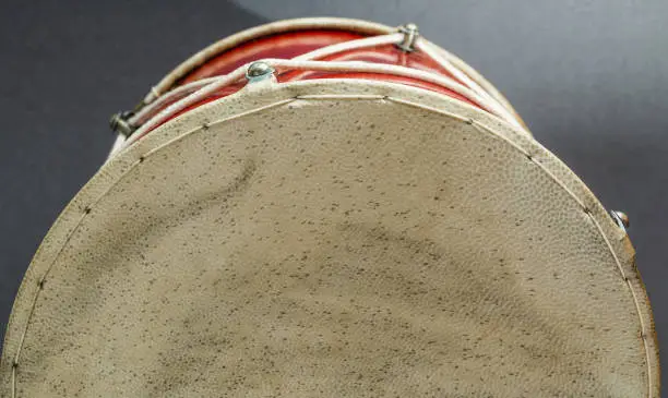 Georgian traditional musical instrument, drum red colored named doli drumhead membrane close-up grey background