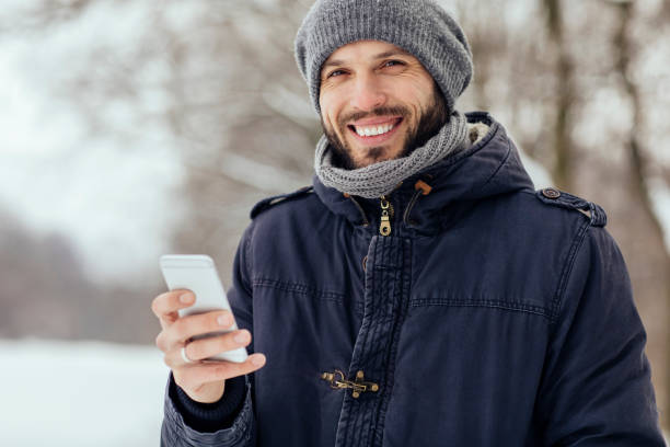 istock Male outdoors at winter with smartphone 1058108886