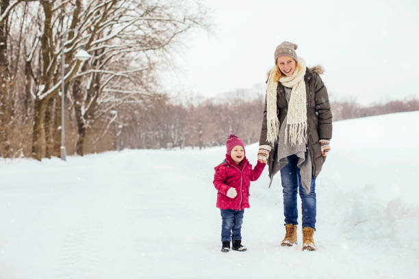 istock Mom and her child enjoying snow day 1058108912