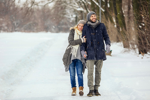 Boyfriend and girlfriend walking in the park on a beautiful Winter day