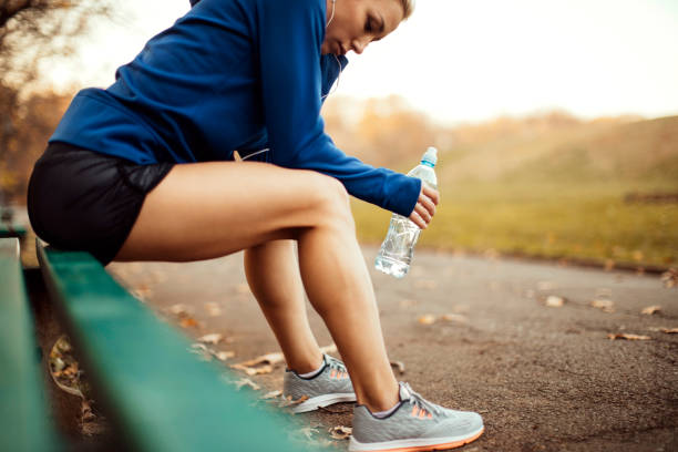 istock Athlete girl on a park bench 1058109610