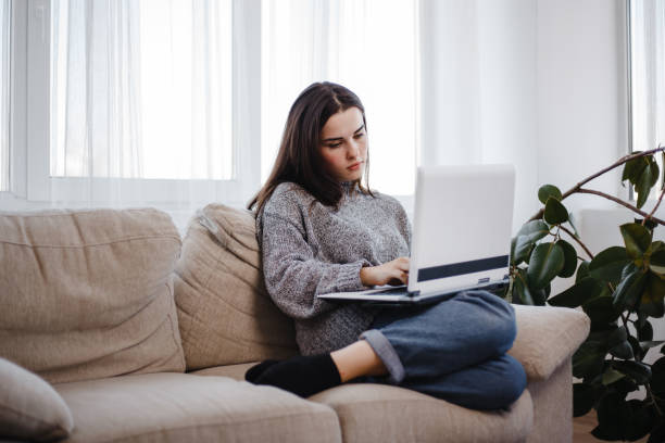 istock young woman typing at laptop at home office 1058111422