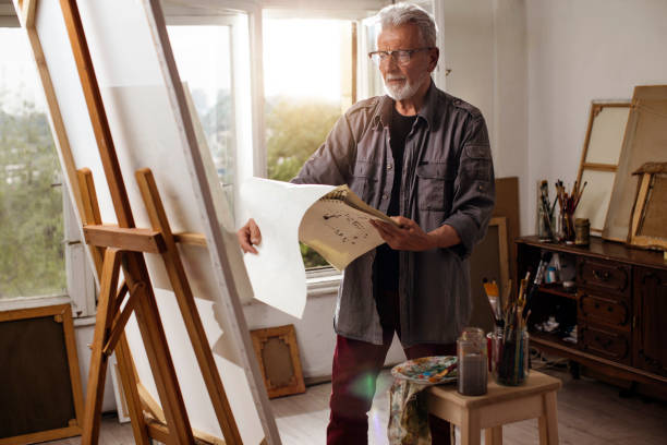 istock Senior man painting 1058111556