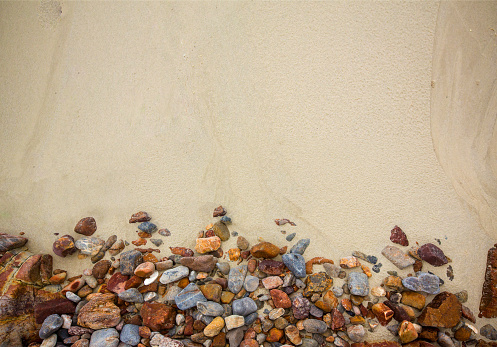 background of gravel and sand space for text here.beach sand and sea stones.