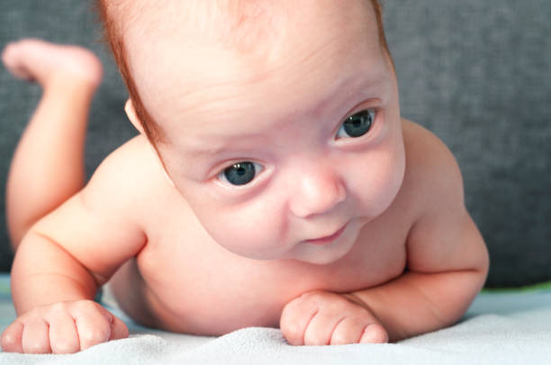 istock A small baby is learning to hold his head. Tinted and blur. Selective focus. 1058112040