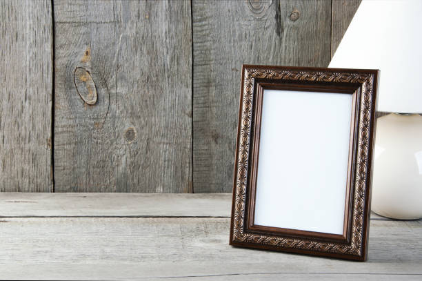 istock Empty brown picture frame on wooden background. 1058118788