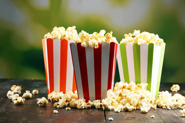 istock Cinema concept with popcorn in green white bag. 1058119598