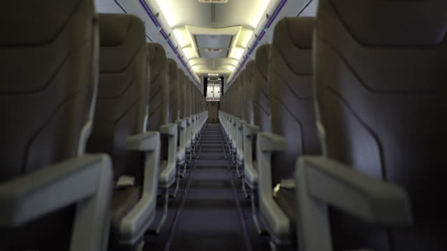View of airplane seats through aisle