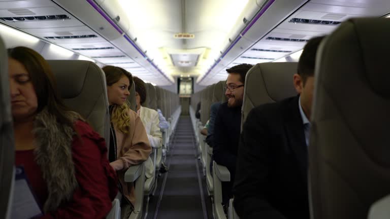 People during a commercial flight some talking others relaxing