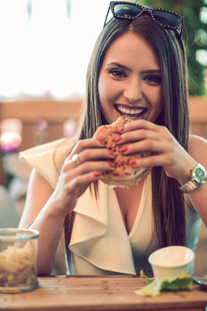 istock Cute Girl Is Eating Burger 1058119786