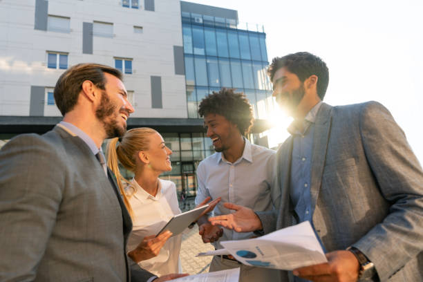 istock Successful business group talking outdoors 1058122644