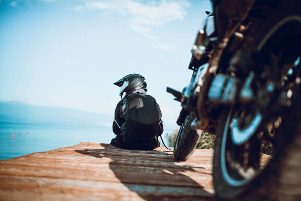 istock Motorcyclist With Specialized Taking A Rest on the Wooden Deck 1058126036