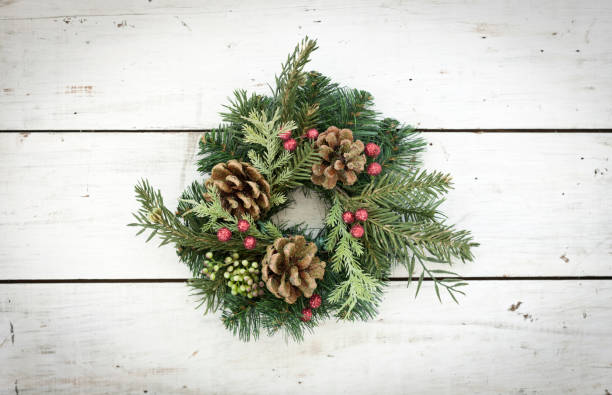 istock Christmas Wreath against an White Old Wood Background 1058126846