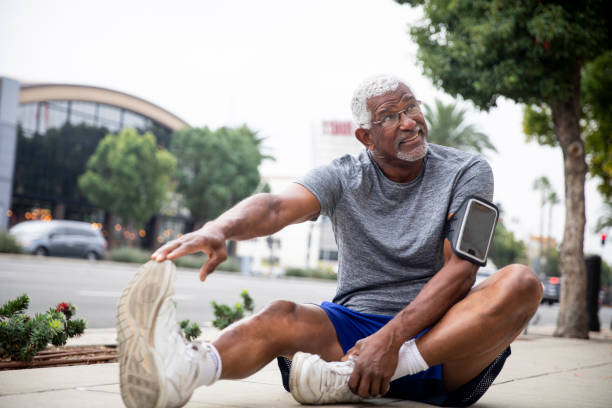 Senior Black Couple Exercising in the City A senior black couple working out in the city. hamstring stock pictures, royalty-free photos & images